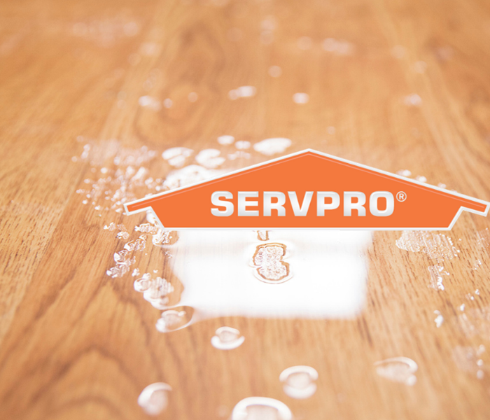 SERVPRO logo on wet wood floor