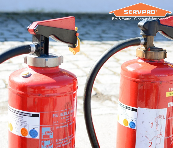 Fire extinguishers with SERVPRO logo.