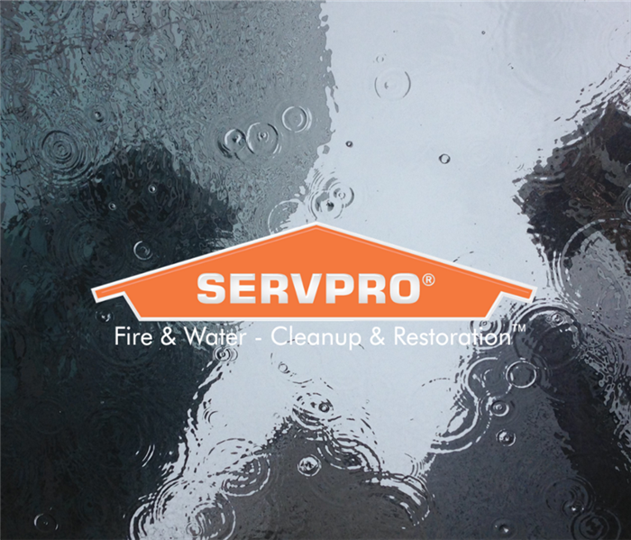 SERVPRO logo with puddle of water in background