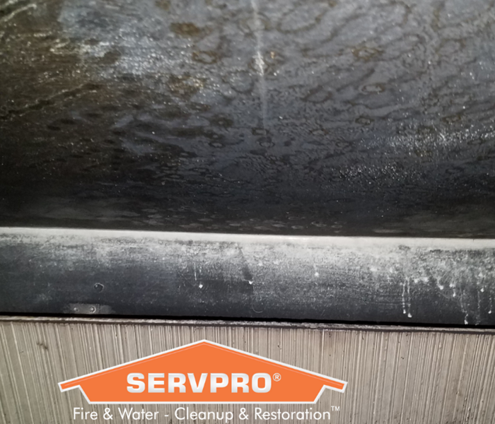 SERVPRO logo with soot on wall