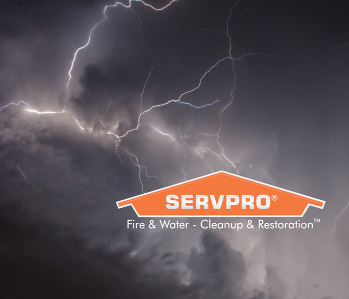 SERVPRO logo with storm clouds and lighting in background