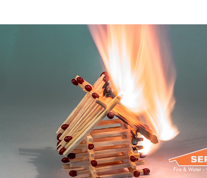 SERVPRO logo with matches in shape of house burning behind