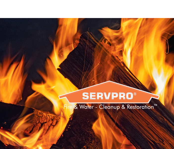 SERVPRO logo with wood on fire behind