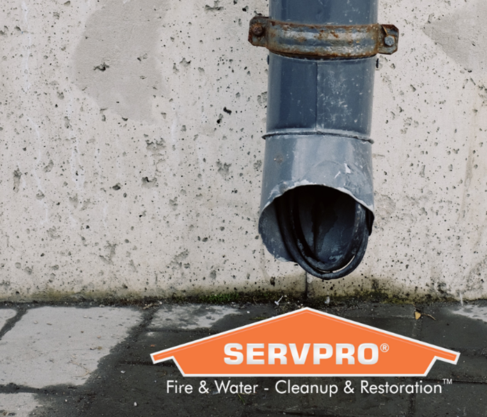 SERVPRO logo with water leaking out of gutter