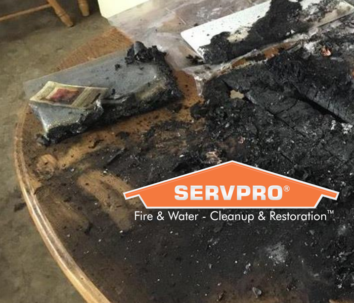 SERVPRO logo on table with charring