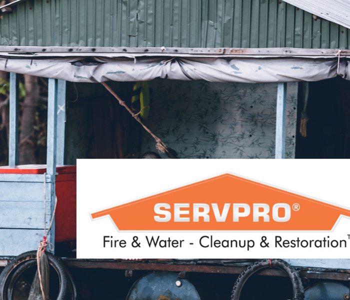 SERVPRO logo with water underneath a home