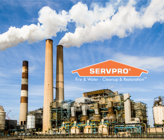 SERVPRO logo in sky over a factory with billowing smoke